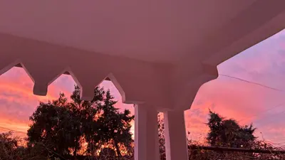 a view of the sunset from a house at Your Bedouin family home in Disah
