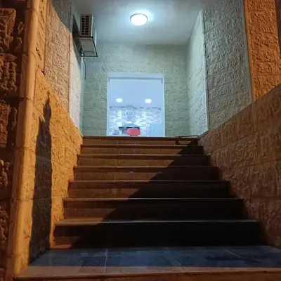 a set of stairs in a building with a window at Petra Eyes in Wadi Musa
