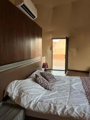 a bedroom with a bed with two pillows on it at Wadi rum camp in Wadi Rum
