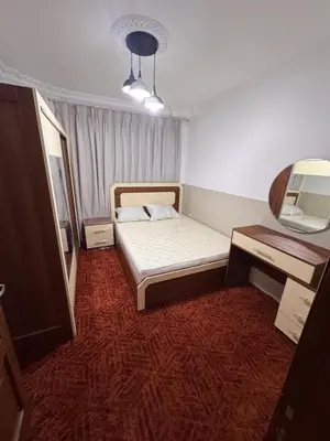 a small bedroom with a bed and a desk at شقه للإيجار قرب جامعة اليرموك in Irbid