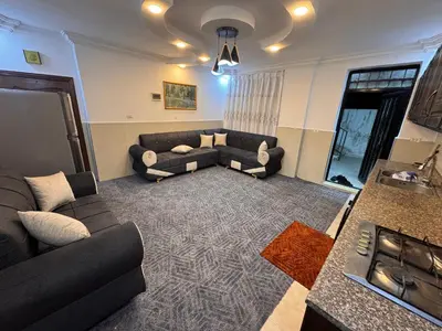 a living room with a couch and a table at شقه للإيجار قرب جامعة اليرموك in Irbid
