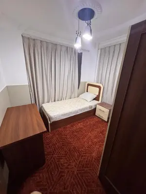 a small room with a bed and a table at شقه للإيجار قرب جامعة اليرموك in Irbid