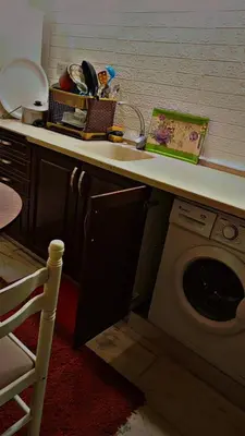 a kitchen with a sink and a washing machine at شقه مفروشه بالكامل متوفر فيها جميع الخدمات in Amman