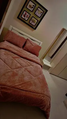 a bedroom with a bed with red pillows on it at شقه مفروشه بالكامل متوفر فيها جميع الخدمات in Amman
