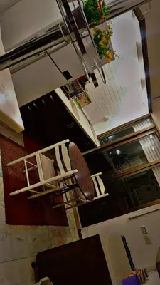 a staircase in a room with a table and chairs at شقه مفروشه بالكامل مكونه من 4 غرف في ضاحيه الأمير راشد عمان شارع مكه in Amman