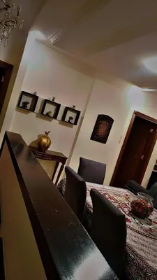 a bedroom with a bed and a table with chairs at شقه مفروشه بالكامل مكونه من 4 غرف في ضاحيه الأمير راشد عمان شارع مكه in Amman