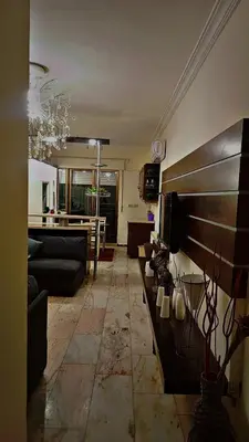 a living room with a couch and a table at شقه مفروشه بالكامل مكونه من 4 غرف في ضاحيه الأمير راشد عمان شارع مكه in Amman
