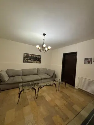 a living room with a couch and a chandelier at فيلا مميزة في عمان - Special Villa in Amman in Amman