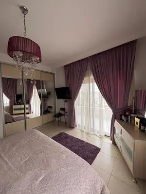 a bedroom with a large bed with purple curtains at فيلا مميزة في عمان - Special Villa in Amman in Amman