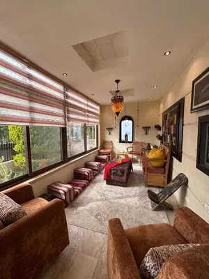 a large living room with couches and chairs and windows at فيلا مميزة في عمان - Special Villa in Amman in Amman