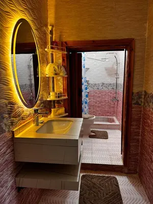 a bathroom with a yellow sink and a mirror at Salem Guesthouse Experience in Al Ḩayy