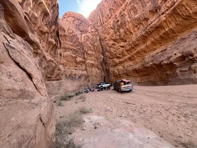 a group of people standing in a slot canyon at Wadi Rum Luxury Trend in Wadi Rum