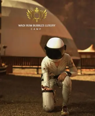 a baseball player kneeling on the ground with an umbrella at WADI RUM BUBBLES lUXURY CAMP in Disah