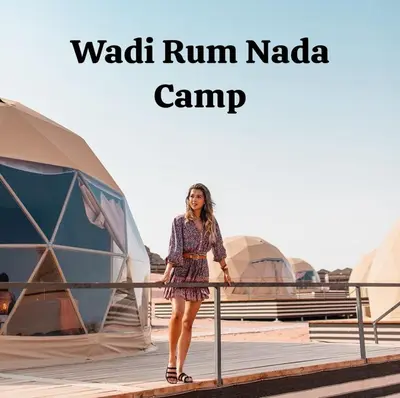 a woman standing in front of a camp at Wadi Rum Nada Camp in Wadi Rum
