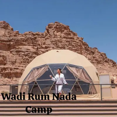 a woman standing in a dome tent in the desert at Wadi Rum Nada Camp in Wadi Rum