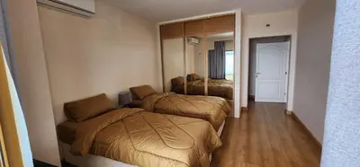 a hotel room with two beds and a mirror at Horizon 3 in Al Qarţū‘īyah