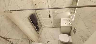 a white bathroom with a toilet and a sink at Horizon 3 in Al Qarţū‘īyah