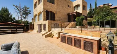 a large house with a courtyard in front of it at Horizon 3 in Al Qarţū‘īyah