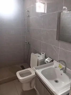 a bathroom with a white toilet and a sink at Wadi rum camp teem in Wadi Rum