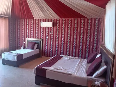 a bedroom with two beds in a tent at Wadi rum camp teem in Wadi Rum