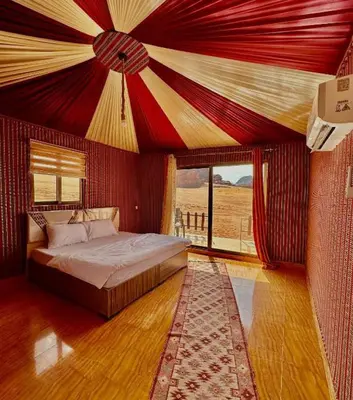 a bedroom with a bed with a red ceiling at ULORA Luxury Camp in Wadi Rum