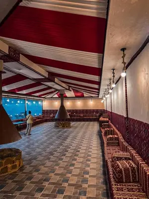 a room with couches and chairs in a building at ULORA Luxury Camp in Wadi Rum