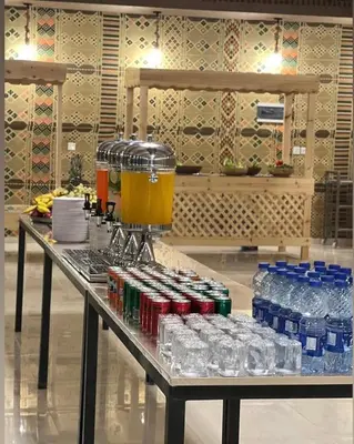 a table with a mixer and a bunch of water bottles at ULORA Luxury Camp in Wadi Rum