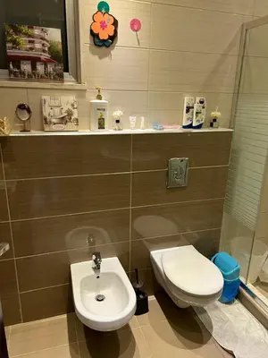 a bathroom with a toilet and a sink at In Balm Society ضاحية النخيل BR 3 Super Deluxe in Amman