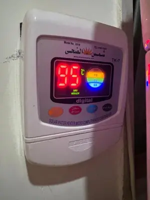 an electronic clock sitting on the side of a refrigerator at In Balm Society ضاحية النخيل BR 3 Super Deluxe in Amman