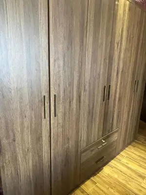 a pair of wooden cabinets in a room at In Balm Society ضاحية النخيل BR 3 Super Deluxe in Amman
