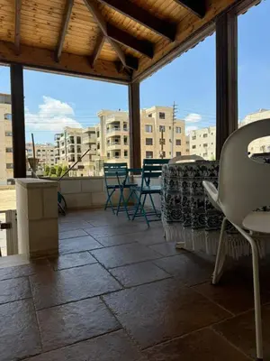 a patio with chairs and tables on a building at In Balm Society ضاحية النخيل BR 3 Super Deluxe in Amman