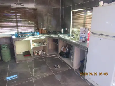 a kitchen with a counter and a refrigerator at اكواخ الملول عجلون 2 in Ajloun