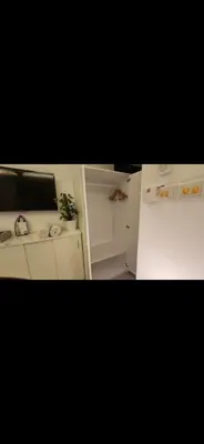 a kitchen with a stove and an open refrigerator at Qqq in Amman