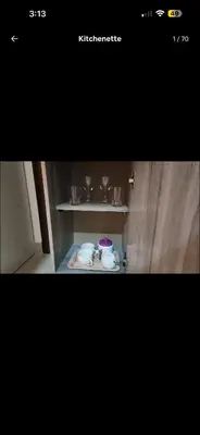 a picture of a shelf with cups and dishes on it at Qqq in Amman