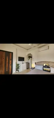 a bedroom with a bed and a television in it at Qqq2 in Amman