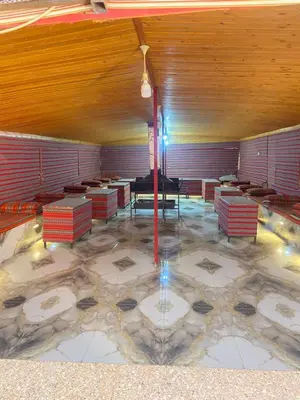 a room with a table and a grand piano at Naif Bedouin tour in Wadi Rum