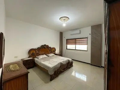 a bedroom with a large bed and a window at Jerash Skyline in Jerash