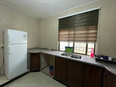 a kitchen with a white refrigerator and a sink at Jerash Skyline in Jerash