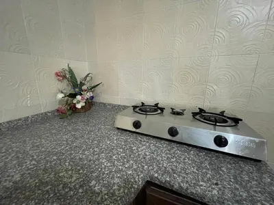 a stove top oven sitting on a counter with flowers at Jerash Skyline in Jerash