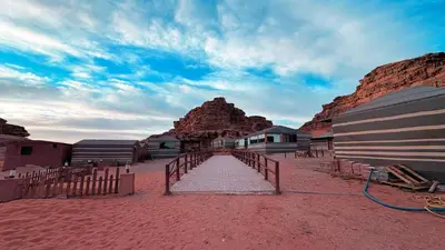 a bridge in the middle of a desert with a mountain at Hello Desert Camp & Tour