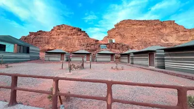 a building with a mountain in the background at Hello Desert Camp & Tour