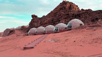 a group of domes in the desert on a hill at Hello Desert Camp & Tour