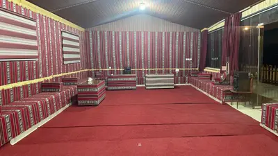a red room with red chairs and a red carpet at Wadi Rum -Lekshary Hamza 55 in Wadi Rum