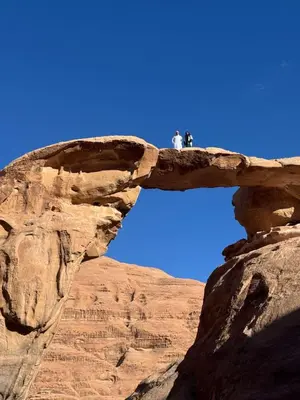 two people standing on top of a rock formation at Monte Carlos Luxury Camp in Disah