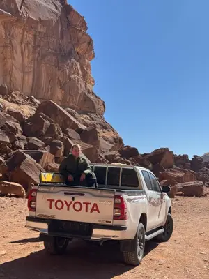 a man sitting in the back of a truck at Monte Carlos Luxury Camp in Disah