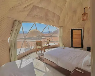 a bedroom with a bed and a large window at Monte Carlos Luxury Camp in Disah