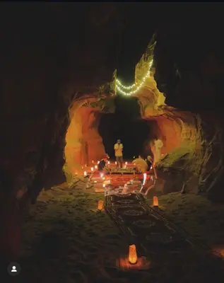 a group of people standing in a cave with lights at Monte Carlos Luxury Camp in Disah