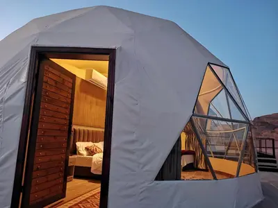 a white tent with a bedroom and a bed at Monte Carlos Luxury Camp in Disah