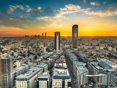 an aerial view of a city at sunset at Rashed's apartments at DAMAC Tower in Amman