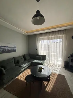 a living room with a couch and a table at شقة مميزة في عبدون هيلز-Modern Apartment in Abdoun Hills in Amman